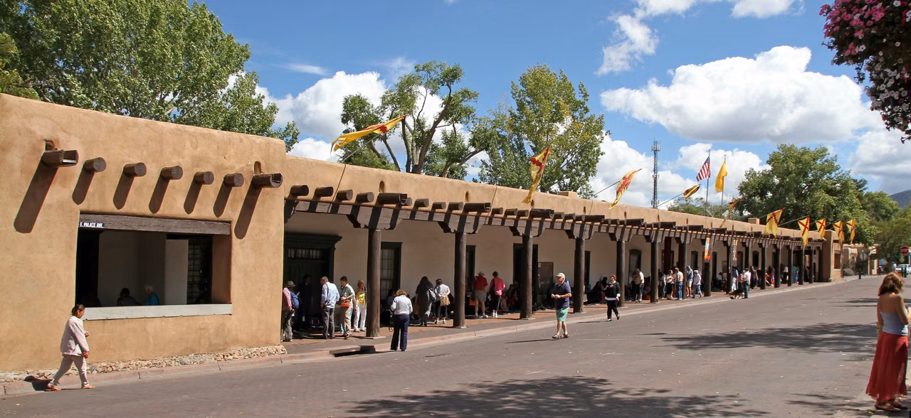 The Palace of the Governors, with its wooden arcade and earth-toned walls, is located north of Plaza de Santa Fe.