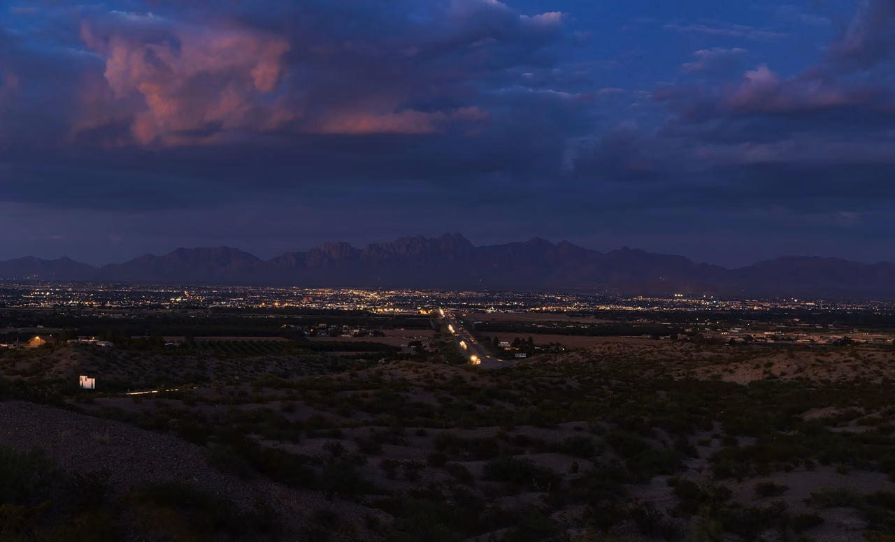 Nightfall over Las Cruces – city lights against the distant mountain ridges.